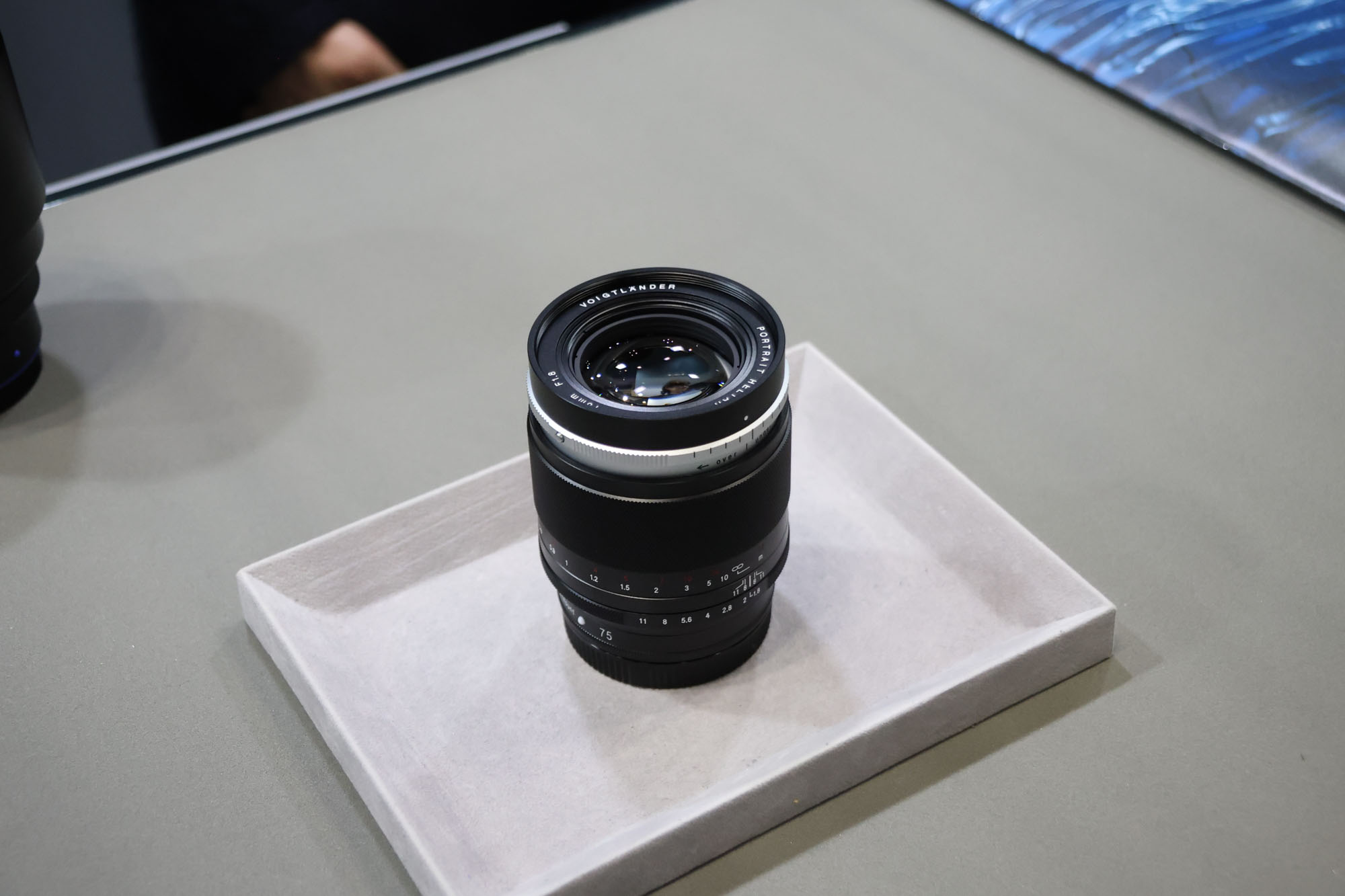 Voigtlander Heliar 75mm f/1.8 lens on a table at the CP+ show