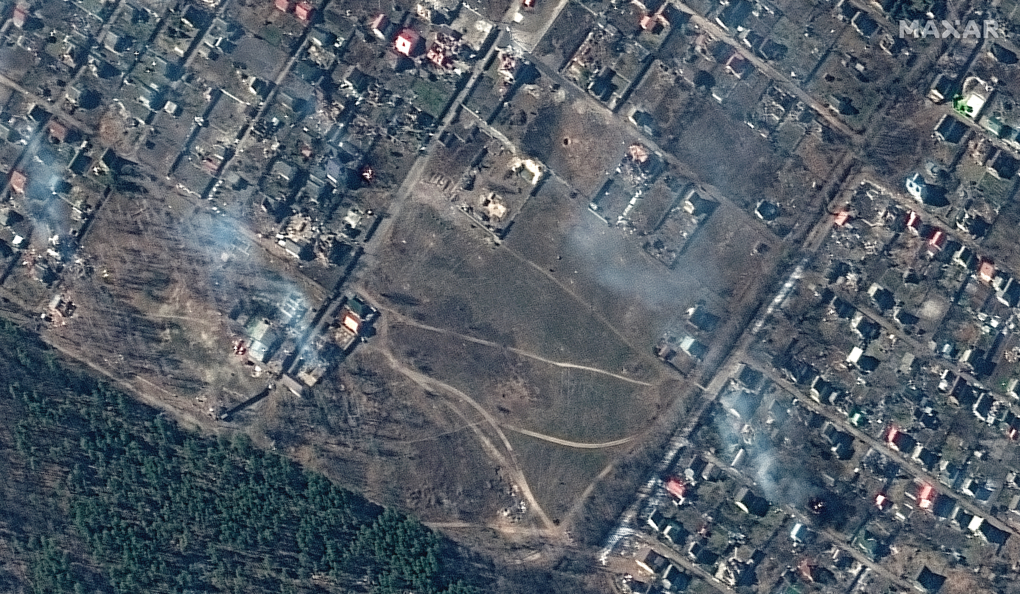 Multispectral and natural color images showing destroyed homes, impact craters and fires in town of Moschun on March 11, 2022 as seen by the WorldView-2 satellite for Maxar Technologies.