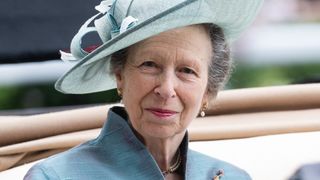 Princess Anne, Princess Royal wears a blue hat and smiles as she attends day one of Royal Ascot 2023 at Ascot Racecourse on June 20, 2023 in Ascot, England.