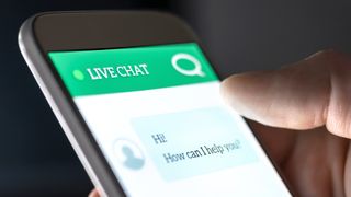 An unseen user interacting with a live chat feed displayed on a smartphone