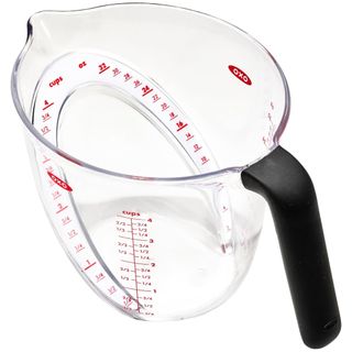 A plastic measuring cup with black handle