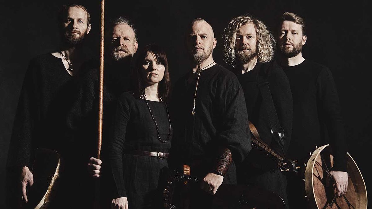 Wardruna holding a spear against a black background