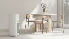 One of the best air purifiers for allergies standing next to a dining table