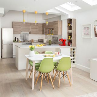 kitchen room and dinning area with white wall and cream colour flooring