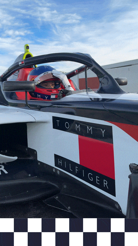 a gif of Hurup Larsen closing her helmet in a Tommy Hilfiger car