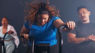 Woman training hard on an elliptical machine