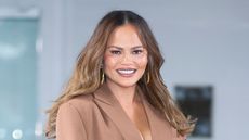 chrissy teigen on a blue background