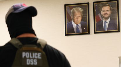 NEW YORK, NEW YORK - AUGUST 04: A federal agent walks past portraits of U.S. President Donald Trump and U.S. Vice President JD Vance as he patrols the halls of the Ted Weiss Federal Building on August 04, 2025 in New York City. The Department of Homeland Security (DHS) is offering new Immigration and Customs Enforcement (ICE) recruits signing bonuses of up to $50,000 and student loan forgiveness as the agency is seeking to meet U.S. President Donald Trump’s goal of hiring 10,000 new ICE agents and deporting a million people a year.