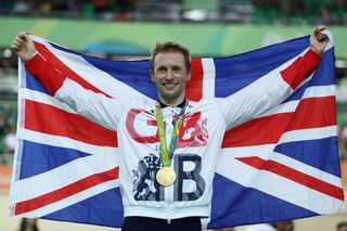 Jason Kenny poses the the Great Britain flag after his fifth career gold medal
