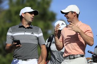Sergio Garcia and Rory McIlroy chat on the tee box during the 2020 Players Championship