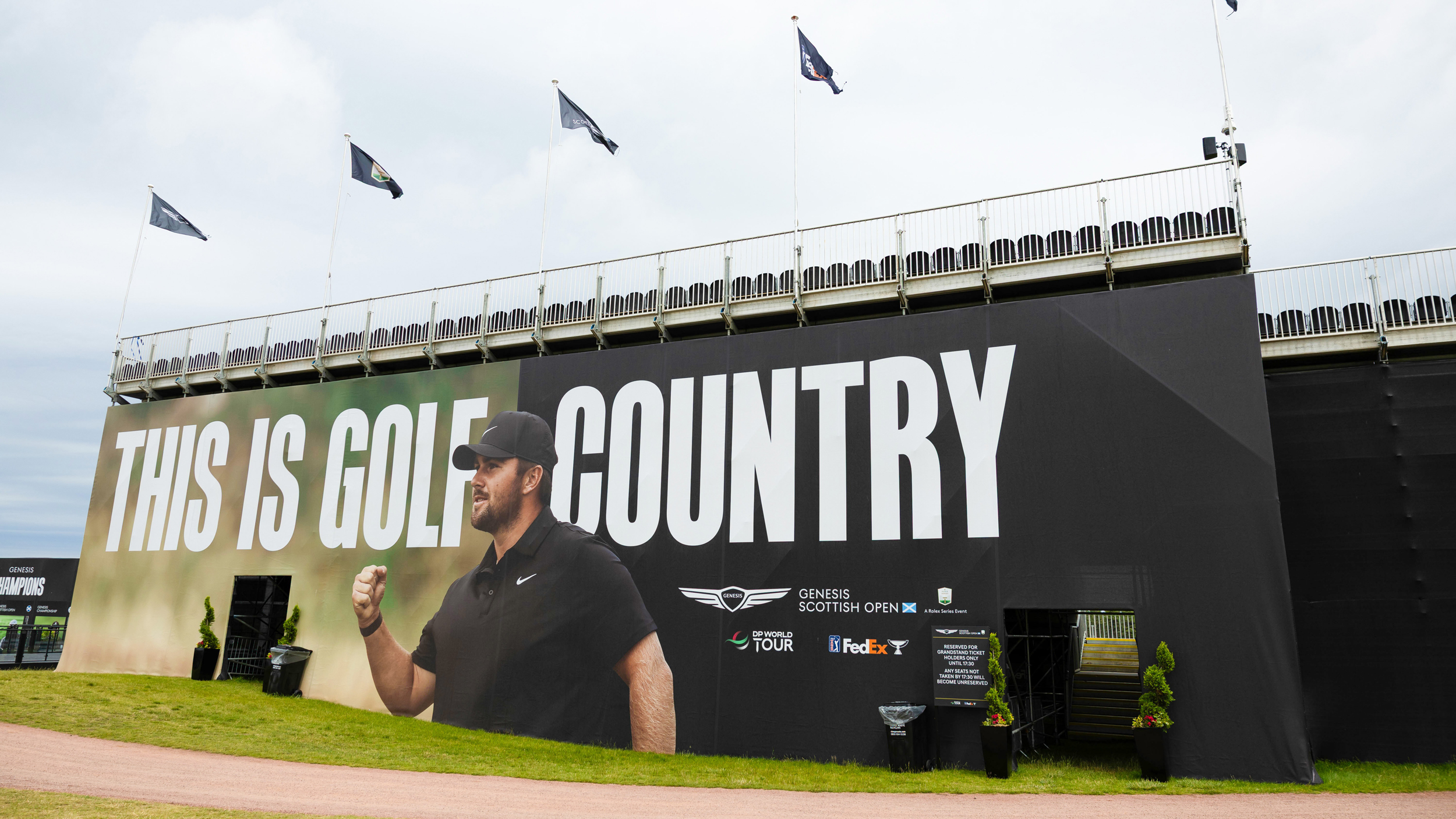 A 'This Is Golf Country' sign with Chris Gotterup on seen on a grandstand at the 2026 Genesis Scottish Open