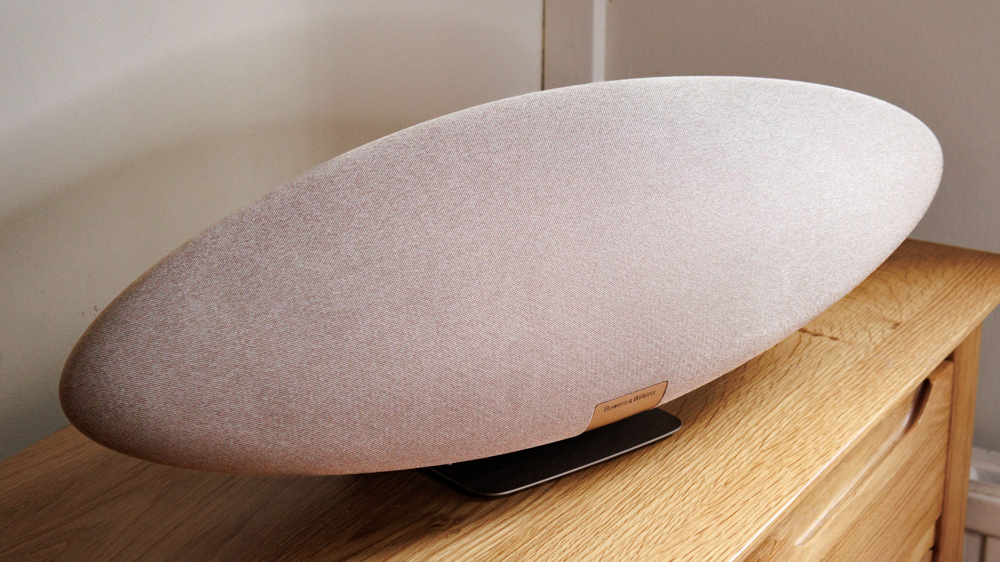 The Zeppelin Pro speaker sitting on a wooden surface