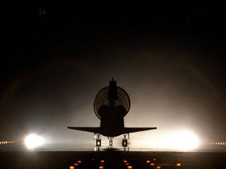 With its drag chute fully deployed, space shuttle Discovery lands on Kennedy's brightly lighted Shuttle Landing Facility runway 15, completing the 9-day, 19-hour, 13-minute and 1-second STS-96 mission. Main gear touchdown was at 2:02:43 a.m. EDT June 6, l