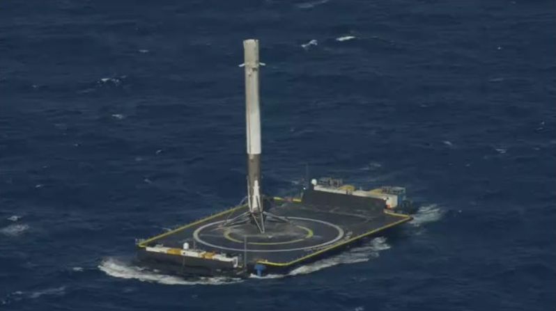 SpaceX&#039;s Falcon 9 rocket booster stands atop its drone ship landing pad after a successful return from space on April 8, 2016 following a Dragon cargo ship launch for NASA.