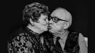 A portrait of Mary and Terry on their tenth wedding anniversary in February, sharing a kiss.