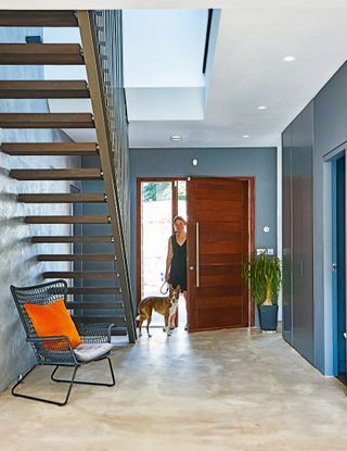 industrial style hallway with lady and dog by front door