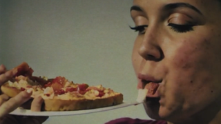 An AI-generated pizza commercial shows a woman eating a plate