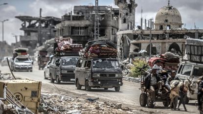 Gazans fleeing Rafah by car, van and cart