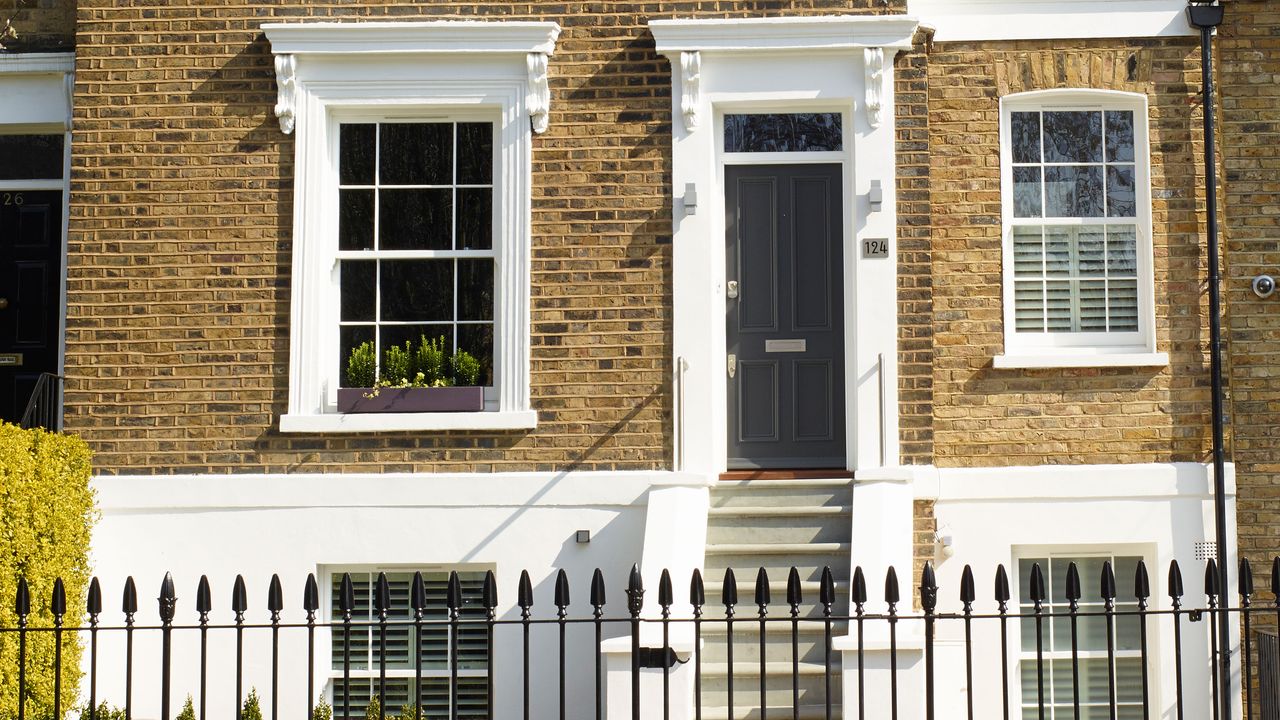 black front door with steps and fence