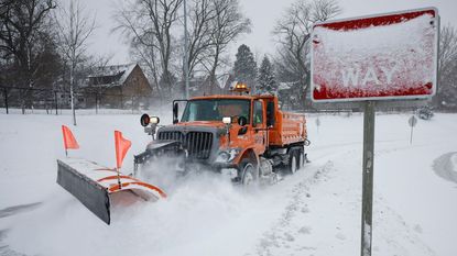 A snowplow clears snow in Iowa