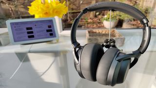 Image shows the Treblab Z7 Pro headphones on a glass table.