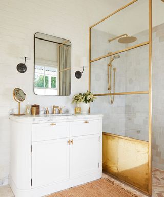 Bathroom with brass hardware and accessories including shower screen
