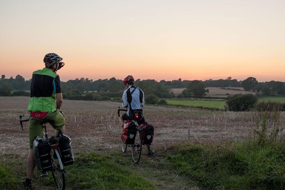 Touring cyclists with bike panniers looking for a pitch for the night