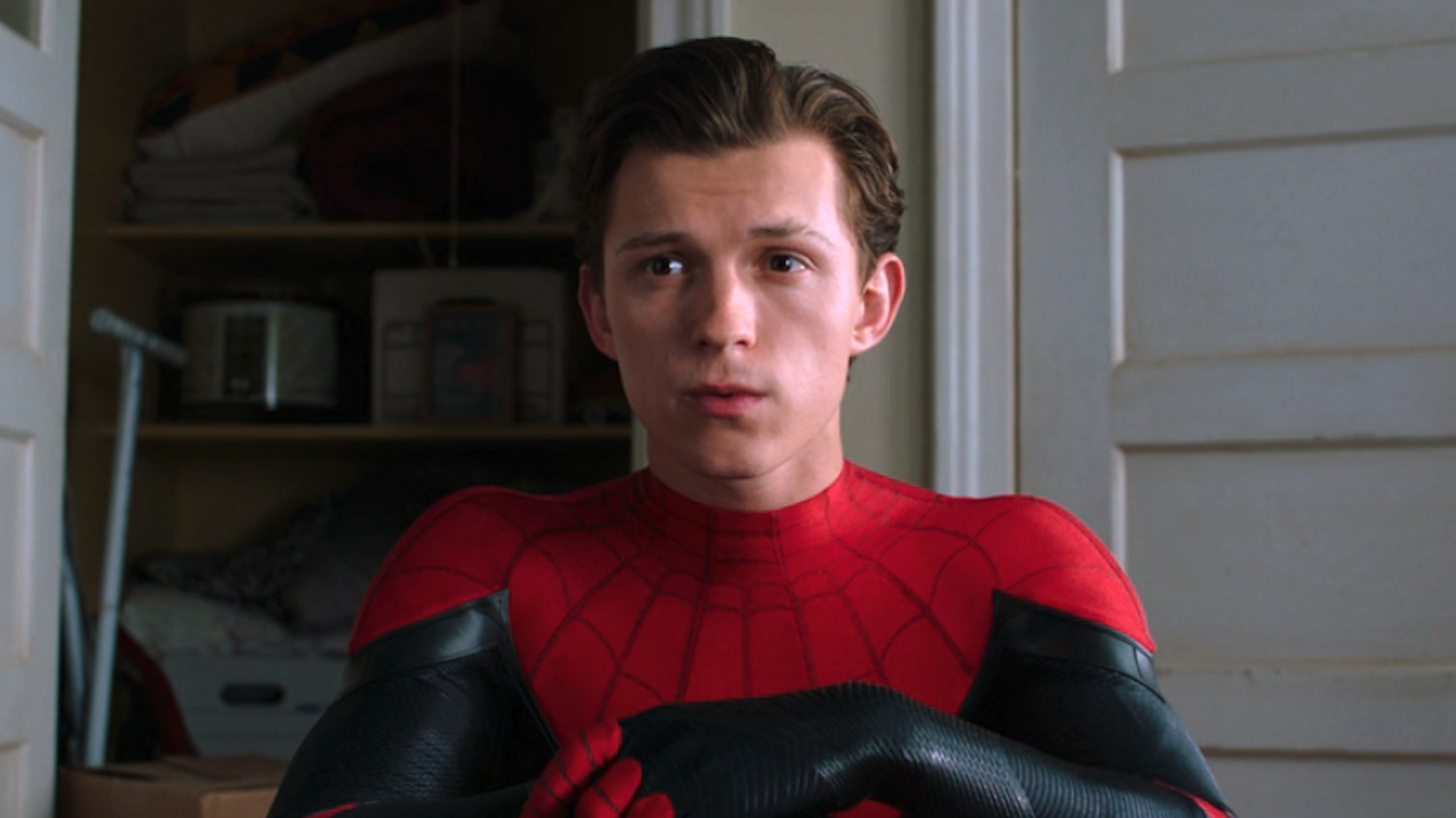 Tom Holland sitting down in Spider-Man suit at the end of Spider-Man: Far From Home