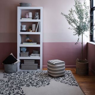 room with open shelf wooden flooring and pink wall