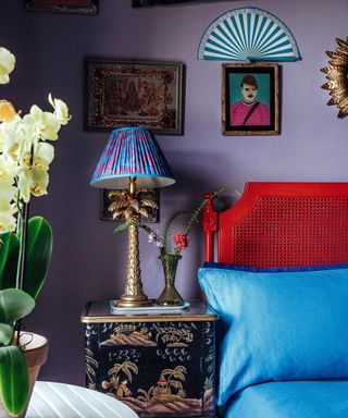 purple maximalist bedroom with red painted headboard