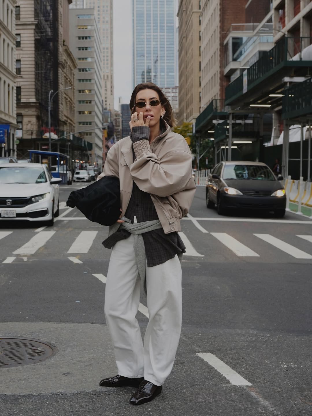 Hannah in white jeans and black loafers