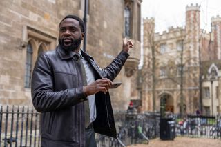 DI Russell Carter (Dipo Ola) outside a church in Ludwig episode 3