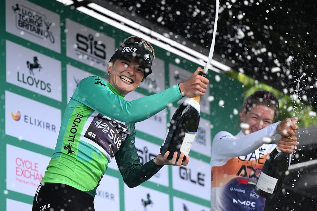 GLASGOW, SCOTLAND - JUNE 08: (L-R) Race winner Ally Wollaston of New Zealand and Team FDJ - SUEZ - Green Leader Jersey and Karlijn Swinkels of Netherlands and UAE Team ADQ on third place celebrate on the podium ceremony after the 10th Tour of Britain Women 2025, Stage 4 a 82.2km stage from Glasgow to Glasgow / #UCIWWT / on June 08, 2025 in Glasgow, Scotland. (Photo by Alex Broadway/Getty Images)