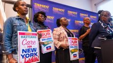 People attend a rally in support of Haitians with Temporary Protected Status