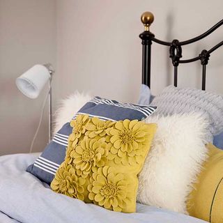 bedroom with bed with colourful cushions