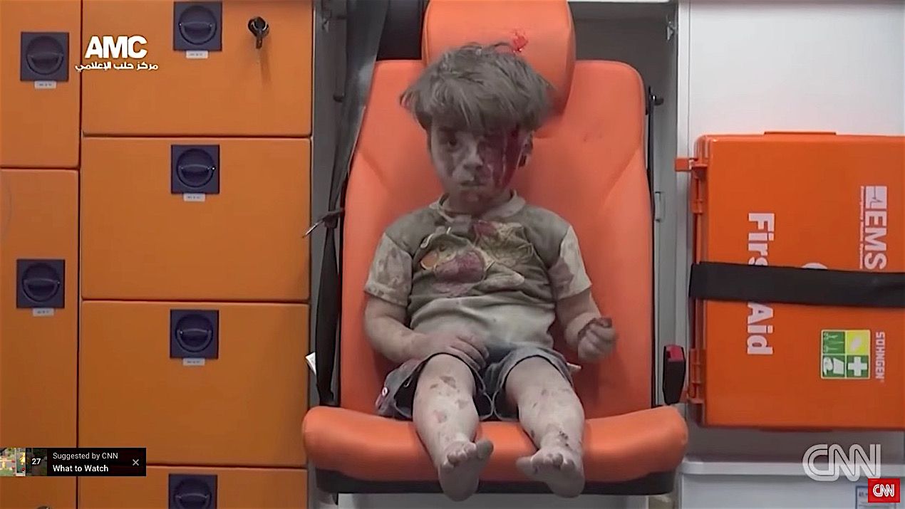 A boy in Aleppo dragged from the rubble of an airstrike