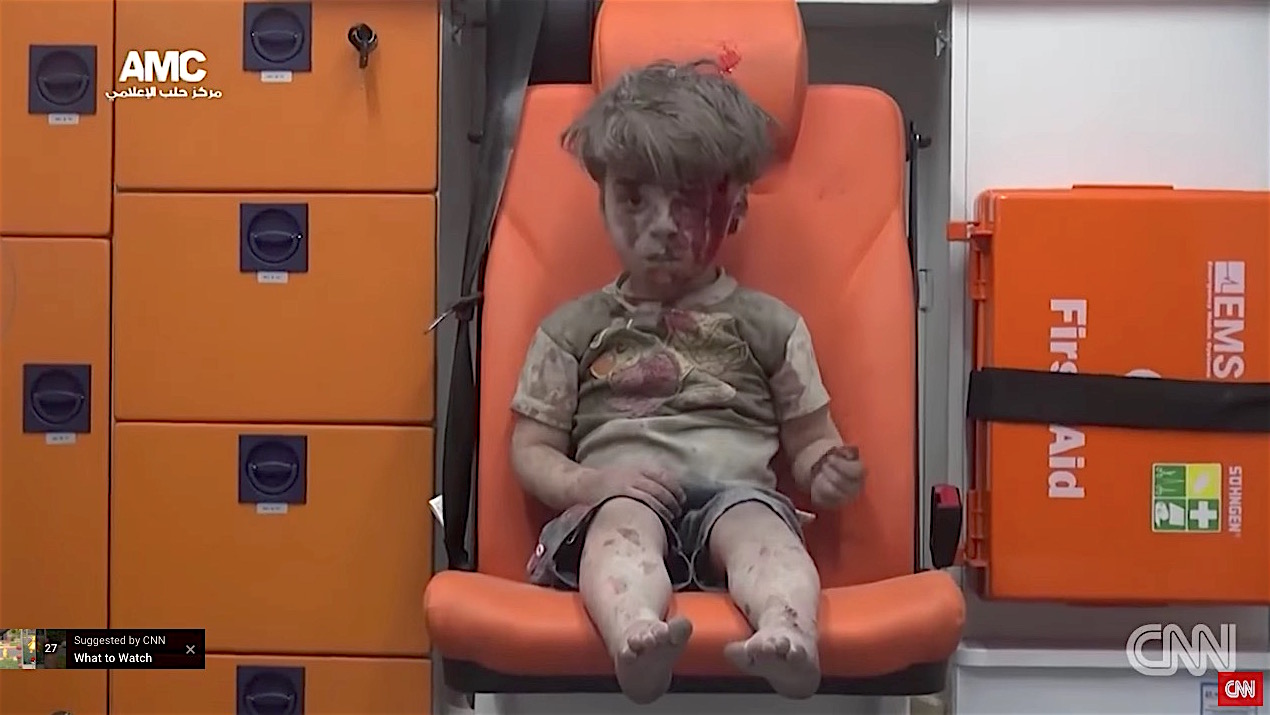 A boy in Aleppo dragged from the rubble of an airstrike