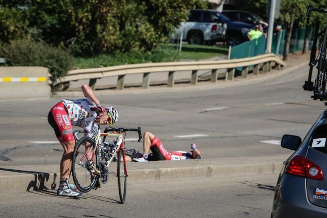 Riders go down after hitting a median with only a few kilometers left.