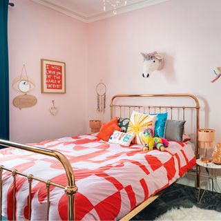 pink girls bedroom with metal bedstead