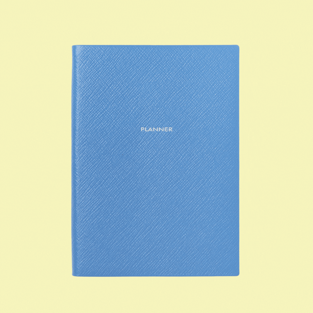 Smythson Soho Planner in Panama shown open and closed in a rotating gif against pale yellow background.