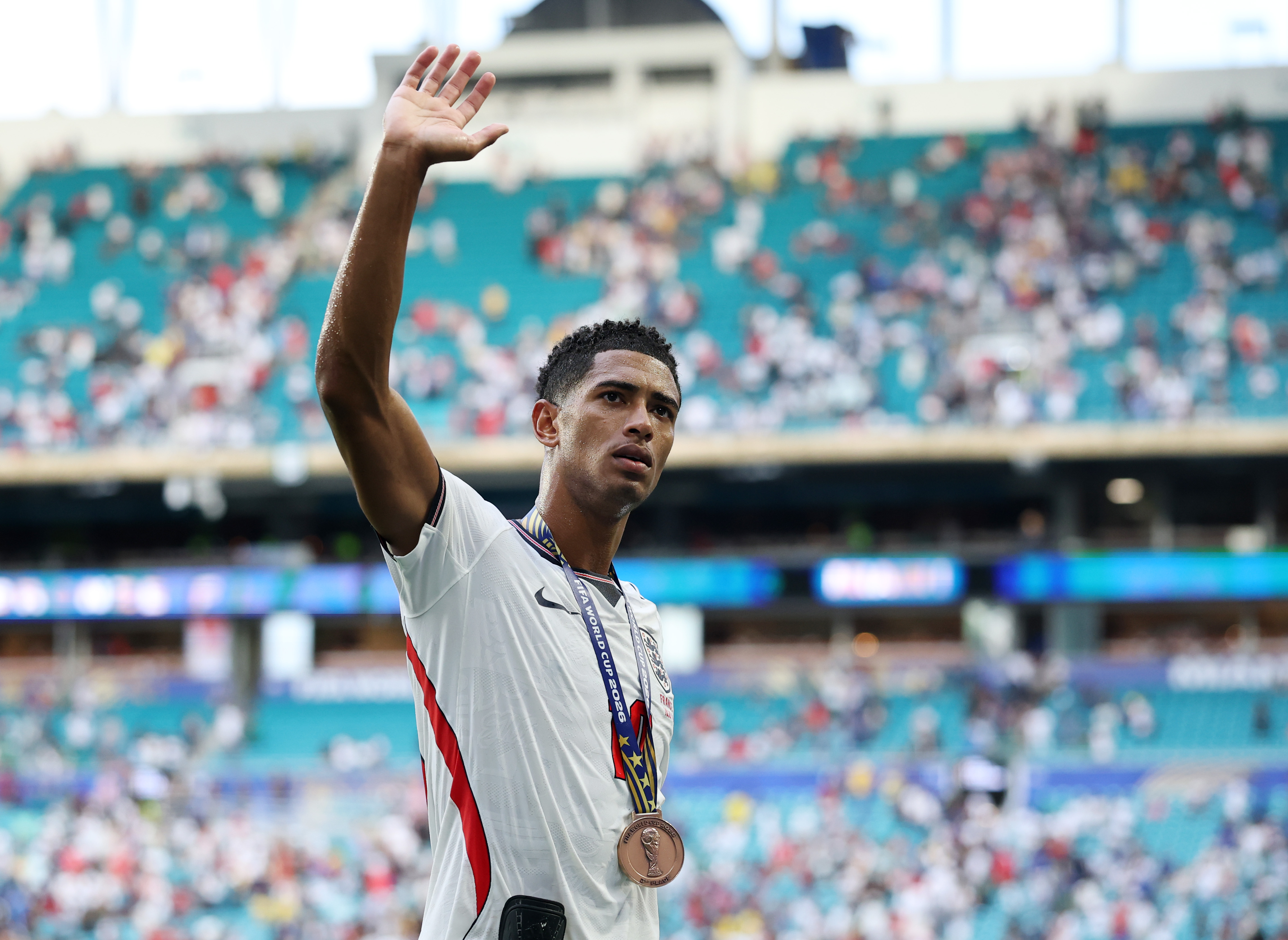 MIAMI GARDENS, FLORIDA - JULY 18: Jude Bellingham #10 of England applauds the fans after receiving the third place medal after the 6-4 win during the FIFA World Cup 2026 Bronze Final between France and England at Miami Stadium on July 18, 2026 in Miami Gardens, Florida. (Photo by Buda Mendes/Getty Images)