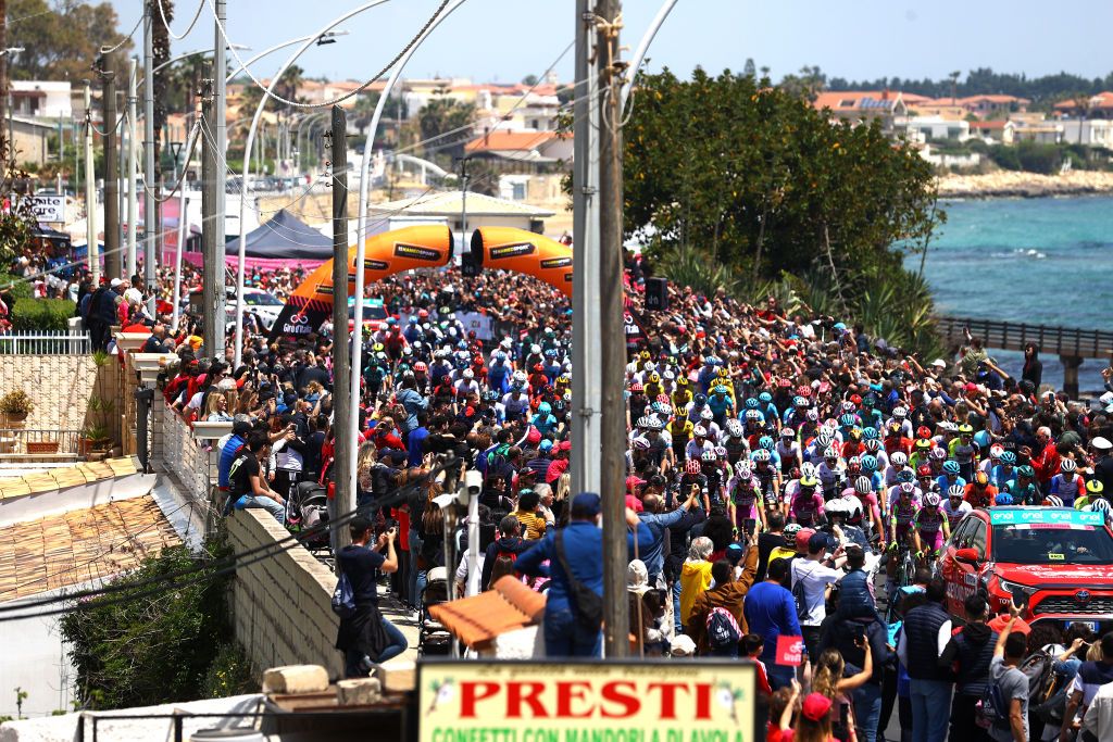 ETNA PIAZZALE RIFUGIO SAPIENZA ITALY MAY 10 A general view of the peloton competing next to the seaside while fans cheer during the 105th Giro dItalia 2022 Stage 4 a 172km stage from Avola to Etna Piazzale Rifugio Sapienza 1899m Giro WorldTour on May 10 2022 in Etna Piazzale Rifugio Sapienza Italy Photo by Michael SteeleGetty Images