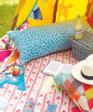 garden picnic with colorful rug and tipi