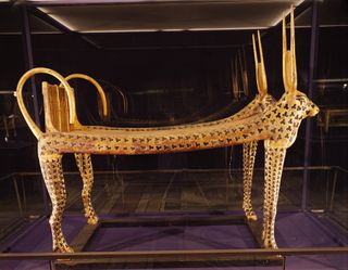 This bed is one of several found in the tomb of Tutankhamun. Made of wood gilded with gold, it has depictions of cows on it. In ancient Egypt, cows were sometimes associated with Hathor, a goddess associated with fertility and love.
