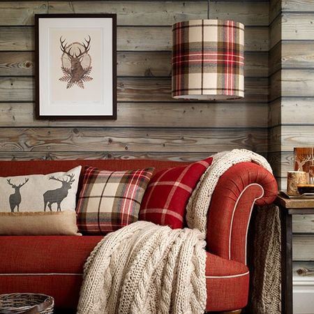 living area with red sofa and drum lampshade