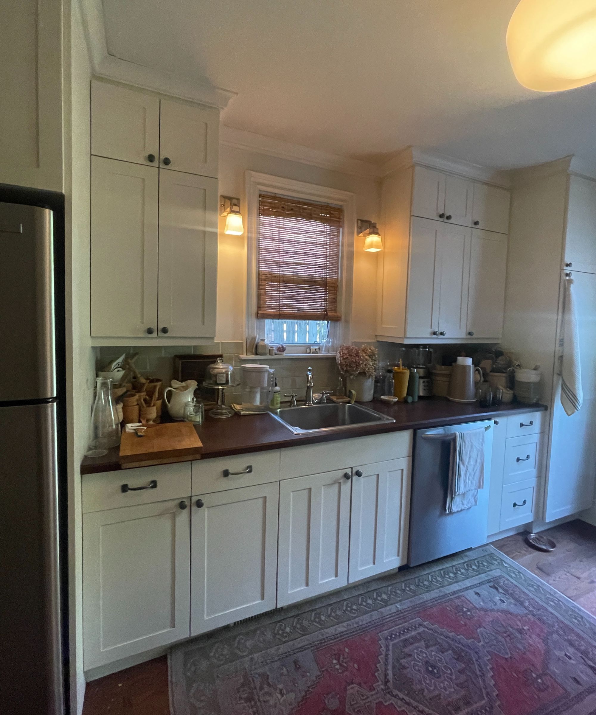 A before photo of a white galley kitchen