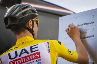 UAE Team Emirates and Tour de France winner Slovenia's Tadej Pogacar signs on a board during the Professional Tour of Surhuisterveen in Surhuisterveen on July 23, 2024. (Photo by Vincent Jannink / ANP / AFP) / Netherlands OUT