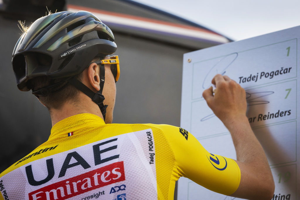 UAE Team Emirates and Tour de France winner Slovenia's Tadej Pogacar signs on a board during the Professional Tour of Surhuisterveen in Surhuisterveen on July 23, 2024. (Photo by Vincent Jannink / ANP / AFP) / Netherlands OUT