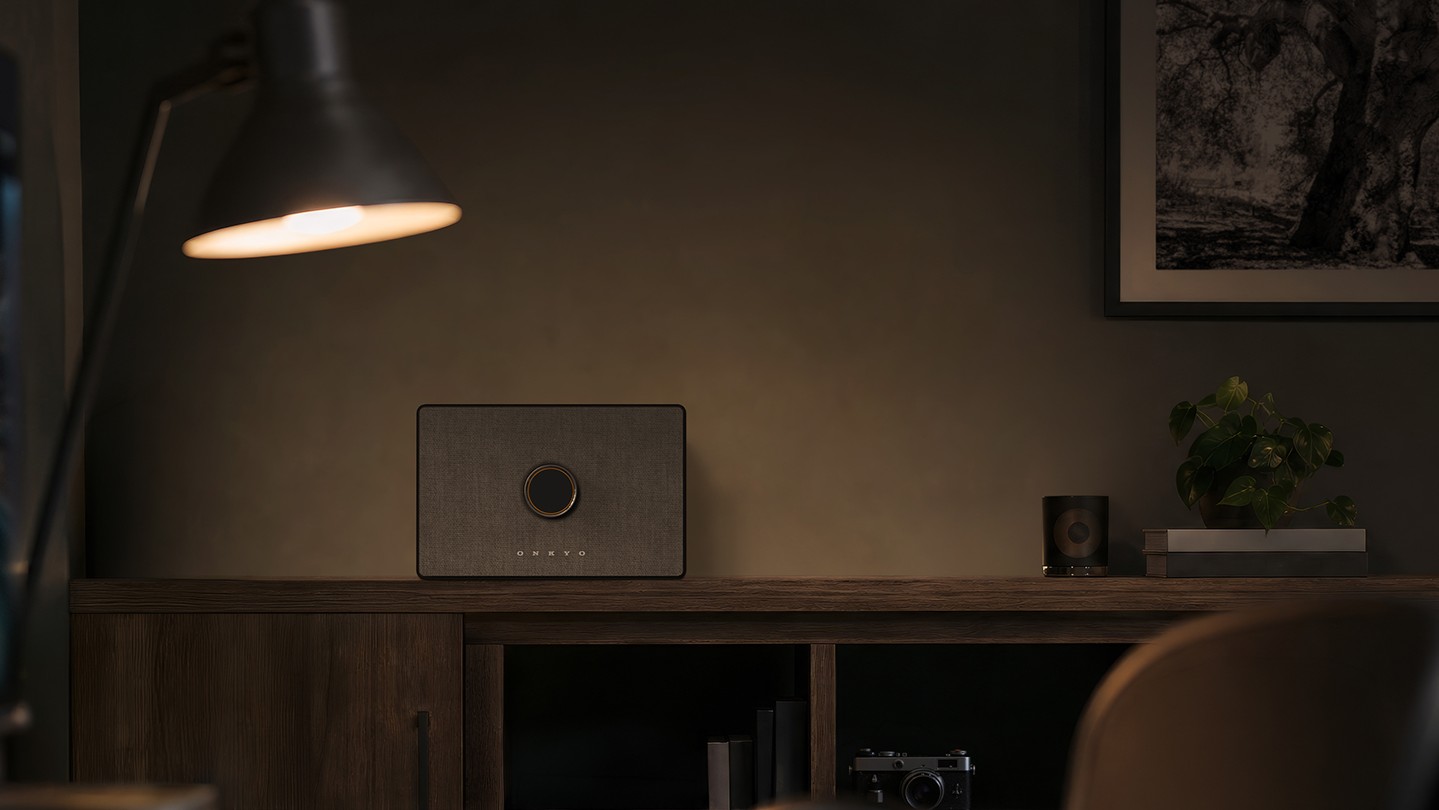 Onkyo GX-AiO 50 wireless speaker system on a wooden cabinet worktop 