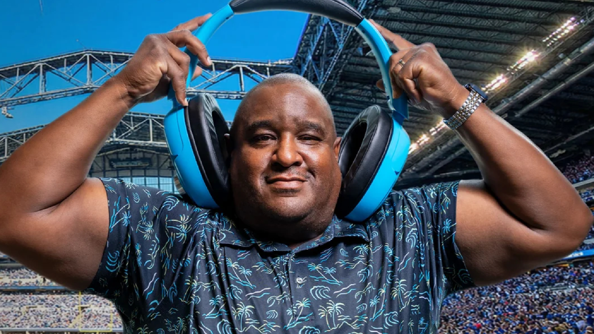 Models demonstrating JLab Audio's oversized Blue XL headphones